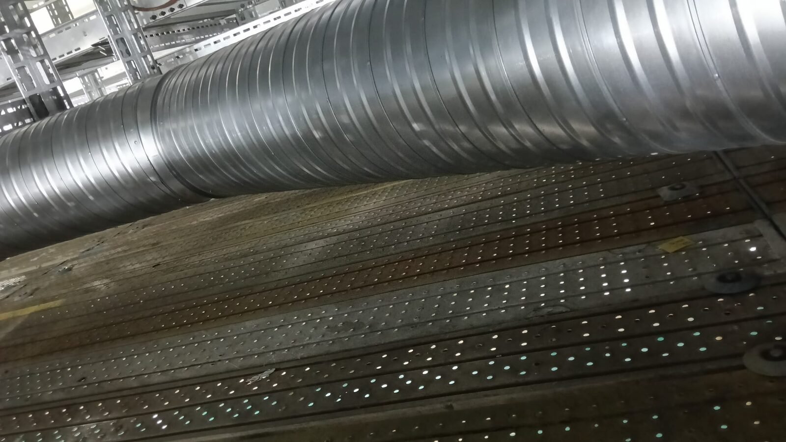 Spiral duct main run traced across the plant at high level