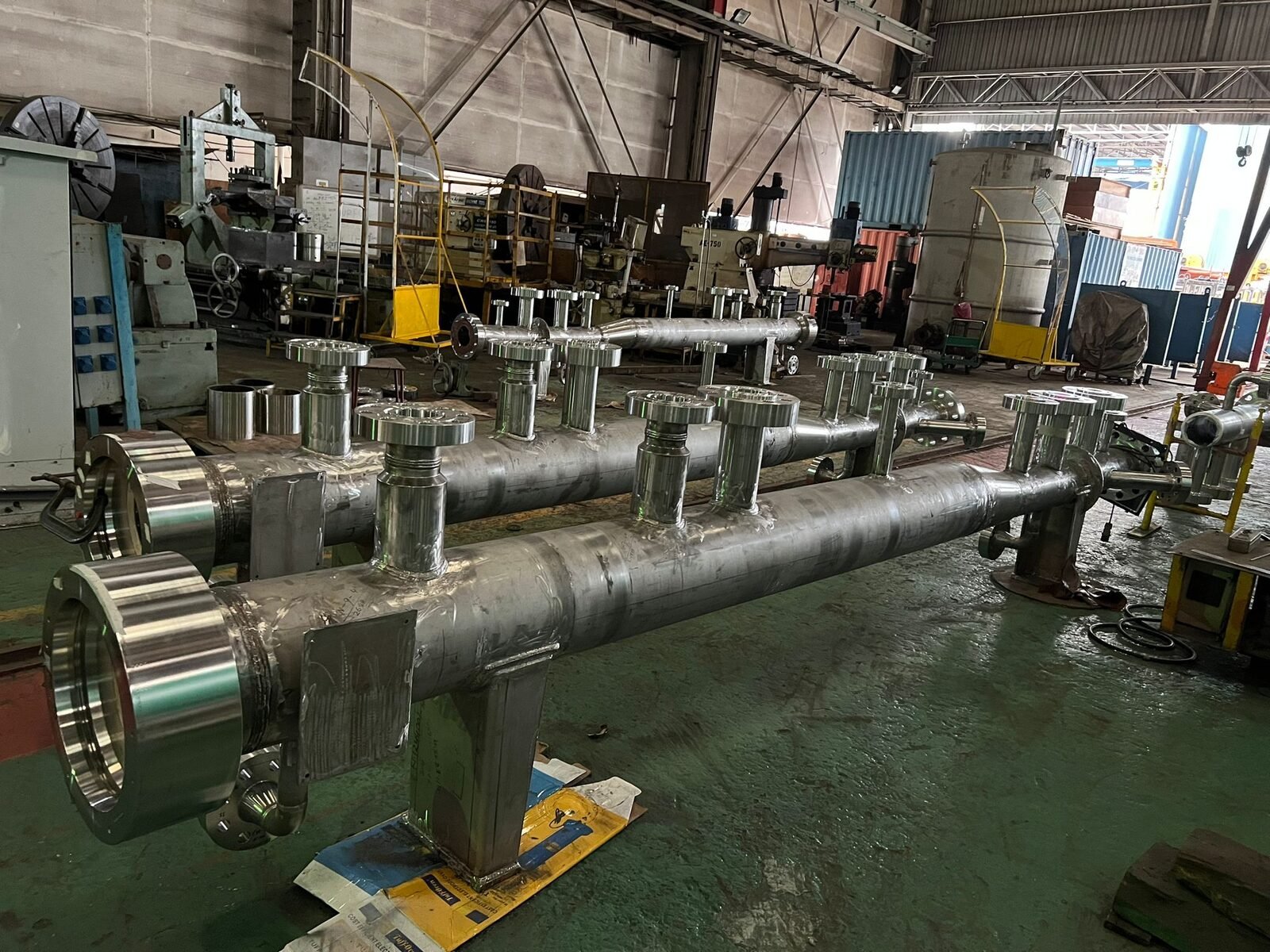 Fabricated manifold spool on stands with branch flanges faced and ready for inspection