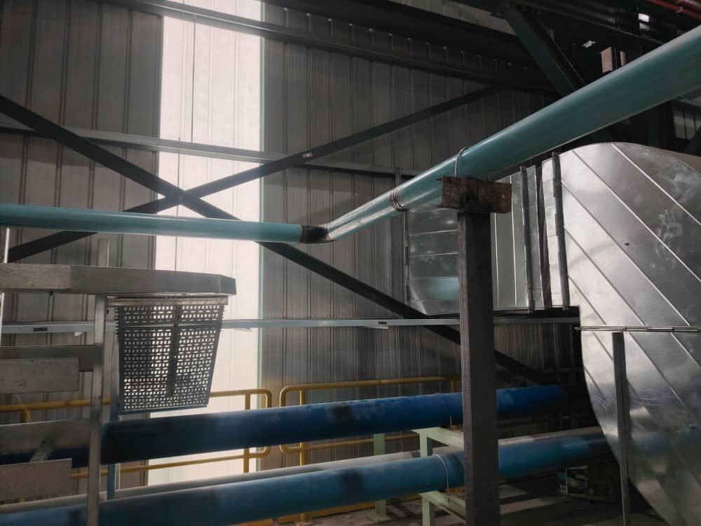 Overhead pipe run crossing a building alongside ductwork