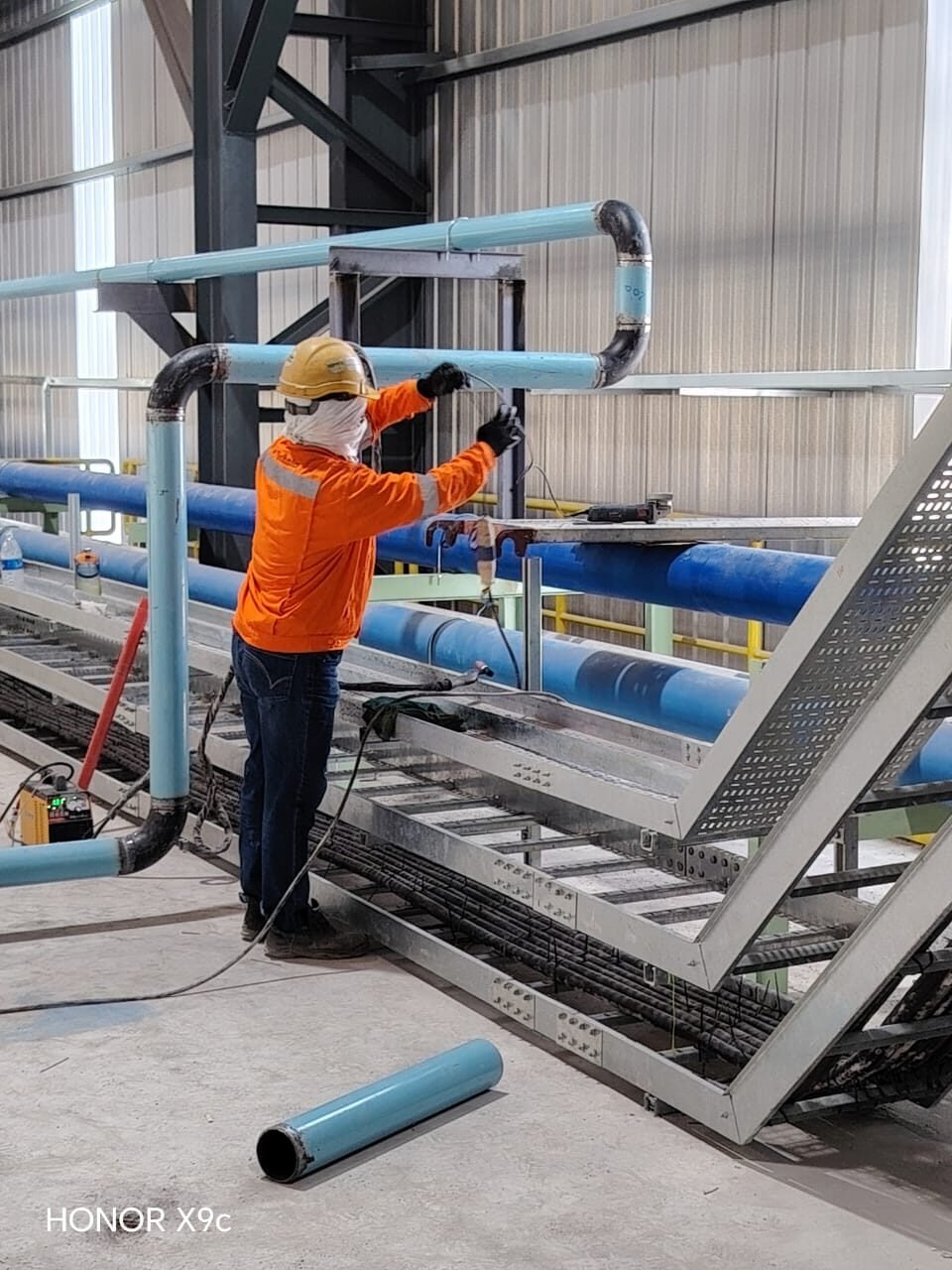 Pipe run installed alongside cable tray on a shared rack