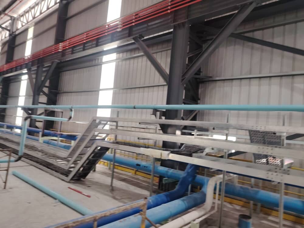 Completed rack carrying multiple pipe runs and cable tray