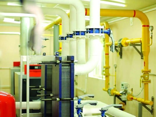 Building plant room with chilled water pipework, valves and pumps