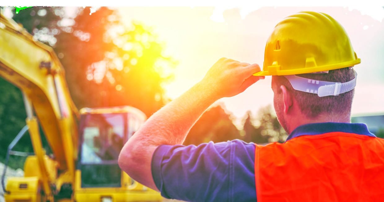 Site supervisor in hard hat and hi-vis reviewing works