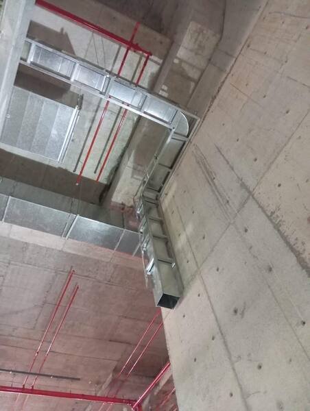 Duct transition turning a corner against a concrete core