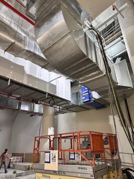 Large duct main and riser routed through a ceiling void