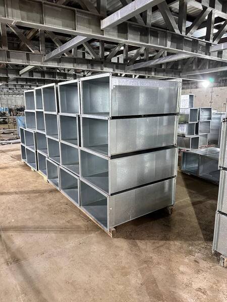 Fabricated rectangular duct sections stacked and ready for installation