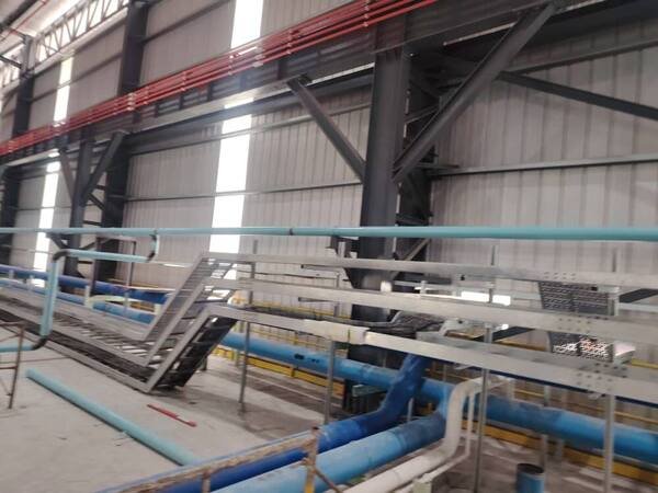 Completed rack carrying multiple pipe runs and cable tray