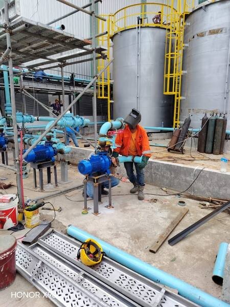 Welding pipework into a pump station adjacent to storage tanks
