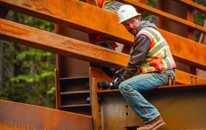 Welder working on a heavy steel beam