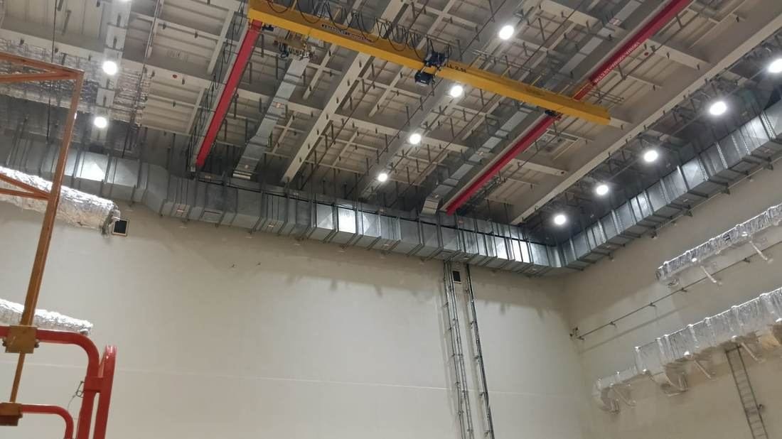 Insulated ductwork and building services routed across the ceiling of a new industrial building