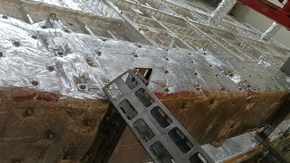 Foil-faced duct insulation and a fabricated support bracket
