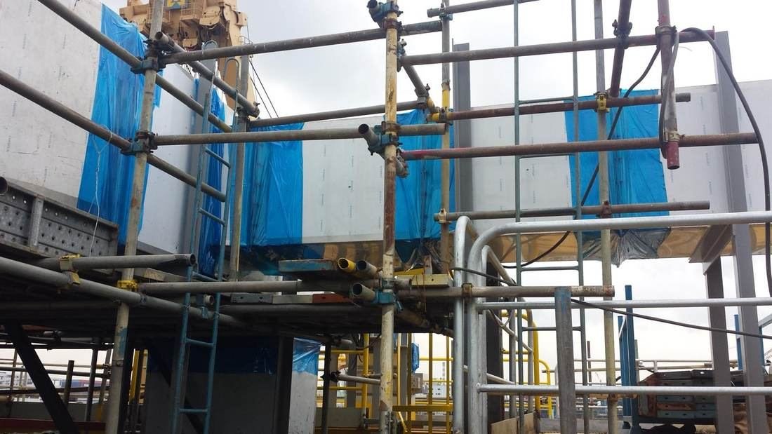 Ductwork installation in progress from access scaffold
